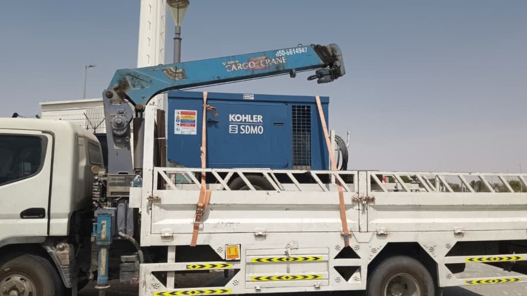 Generator carried on a boom truck flatbed