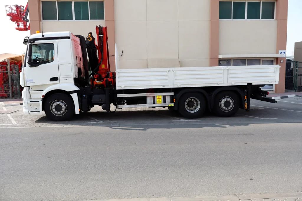 White boom truck crane with a flatbed in Abu Dhabi