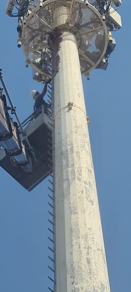 Manlift basket working at a telecom mast