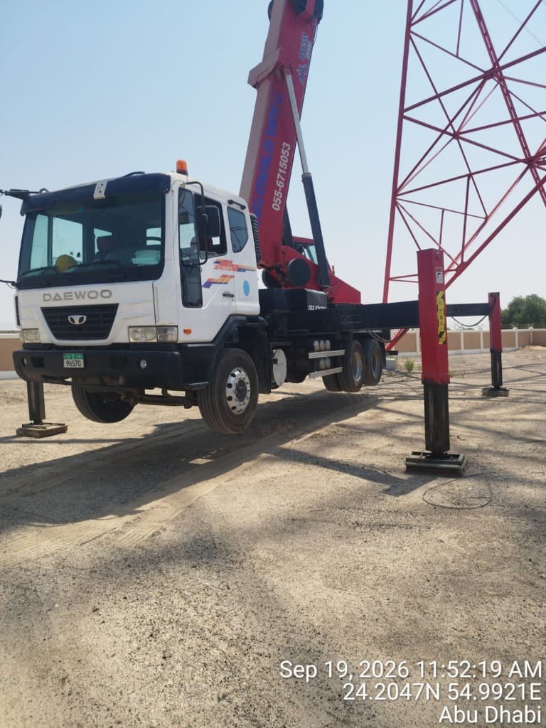 Manlift basket positioned against the steel of a lattice tower